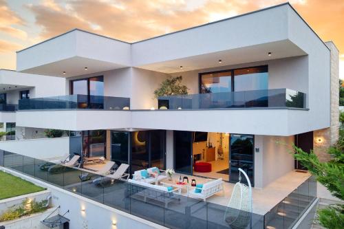 an image of a modern house with a pool at Villas Lucy - 1 Lemon -outdoor pool , 2 Cherry-indoor pool and 3 Plum-outdoor pool in Marina