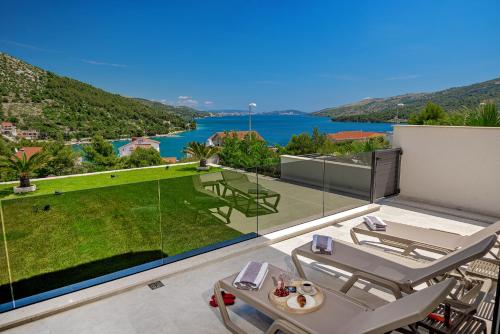 a view of the water from the balcony of a house at Villas Lucy - 1 Lemon -outdoor pool , 2 Cherry-indoor pool and 3 Plum-outdoor pool in Marina