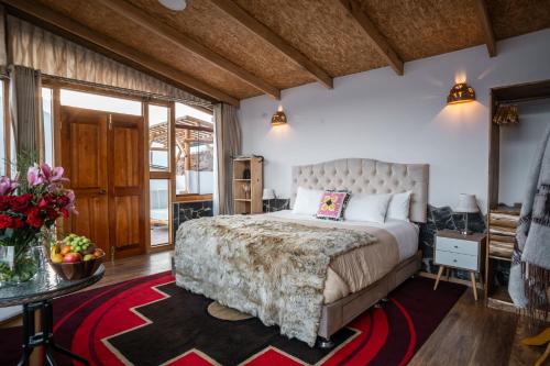 a bedroom with a large bed and a large window at Stardome Spiritual Experience in Ollantaytambo