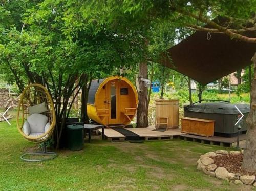 a tent and a hammock under a tree at Zielony Zakątek Karpacz Apartamenty in Karpacz