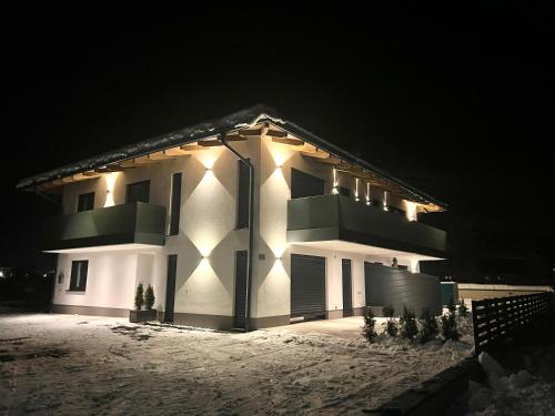 a house with lights on the side of it at night at Alpin Apartments in Radstadt