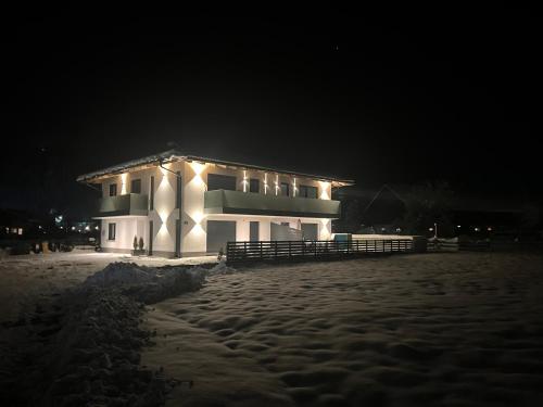 a building with lights on the side of it at night at Alpin Apartments in Radstadt