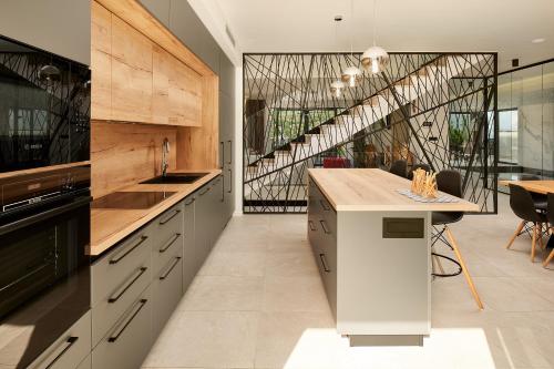 a kitchen with a counter and a staircase at Villas Lucy - 1 Lemon -outdoor pool , 2 Cherry-indoor pool and 3 Plum-outdoor pool in Marina