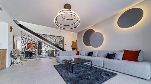 a living room with a couch and a table at Villas Lucy - 1 Lemon -outdoor pool , 2 Cherry-indoor pool and 3 Plum-outdoor pool in Marina