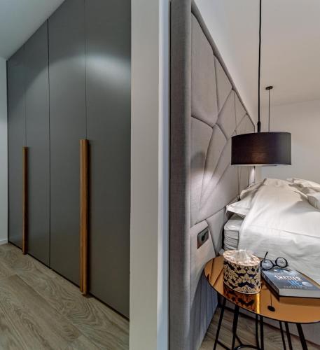 a bedroom with a bed and a table with a lamp at Villas Lucy - 1 Lemon -outdoor pool , 2 Cherry-indoor pool and 3 Plum-outdoor pool in Marina