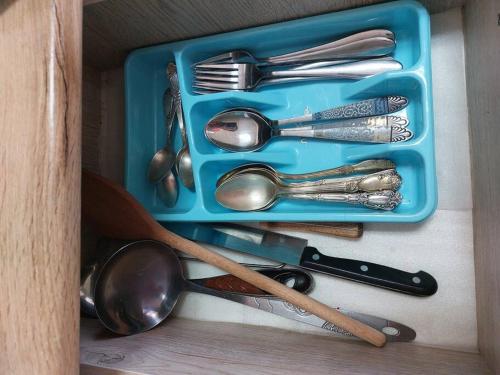 a blue tray with silver utensils in a drawer at Wonderful_place_for 2 persons in Tbilisi City