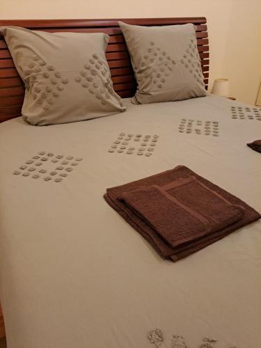 a white bed with two pillows and a towel on it at Little Paradise AL - Fão in Fão