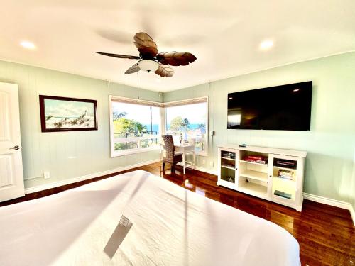 a bedroom with a bed and a flat screen tv at Endless Vistas On The Cove Perfection - Spa, Pet-Friendly, Stunning Views, Large Parking & AC in San Diego