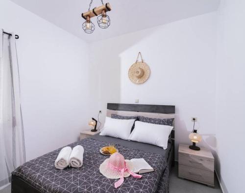 a bedroom with a bed with shoes on it at Stella Apartment in Kaloi Limenes