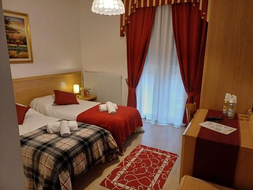 Postel nebo postele na pokoji v ubytování Albergo Dalla Mena