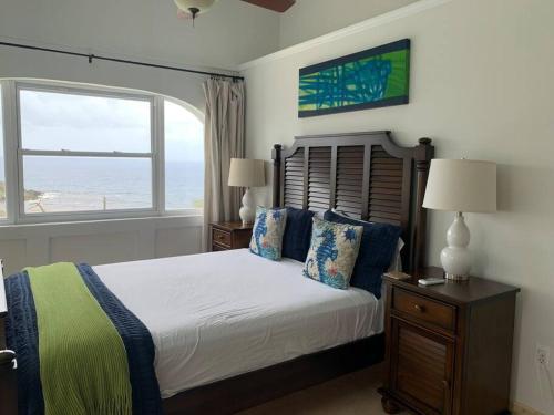 a bedroom with a bed with a view of the ocean at Breathtaking ocean views in Judiths Fancy in La Grande Princesse