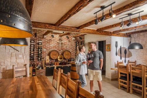 a man and a woman standing in a wine cellar at Villas Lucy - 1 Lemon -outdoor pool , 2 Cherry-indoor pool and 3 Plum-outdoor pool in Marina