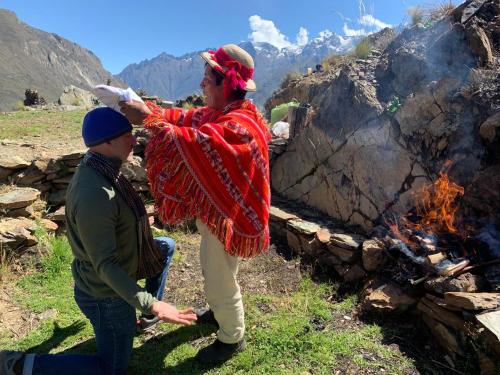 a man and a woman standing next to a fire at Stardome Spiritual Experience in Ollantaytambo