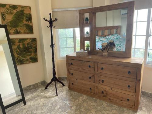 a bedroom with a dresser with a large mirror at Casa Neblinas in San Carlos