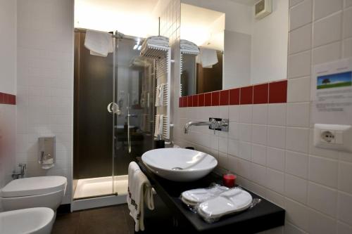 a bathroom with a sink and a toilet and a shower at Donna Eleonora Residence in Matera