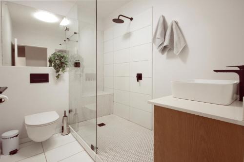 a bathroom with a shower and a toilet and a sink at Luxury on Dorp in Stellenbosch