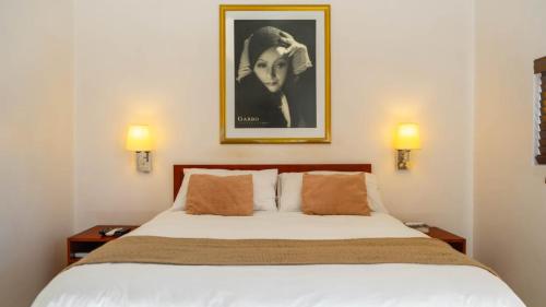 a bedroom with a large bed with two night stands at Broadway Boston in Cape Town