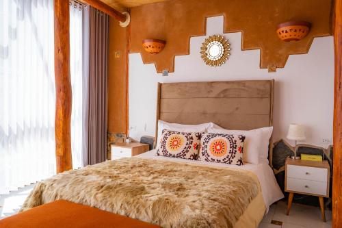 a bedroom with a large bed with pillows on it at Stardome Spiritual Experience in Ollantaytambo