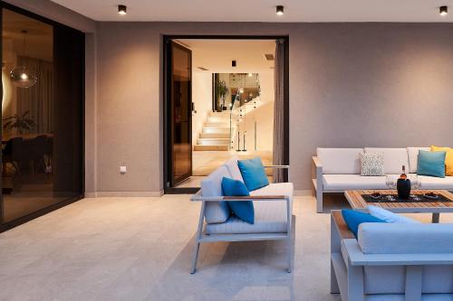a living room with couches and a table at Villas Lucy - 1 Lemon -outdoor pool , 2 Cherry-indoor pool and 3 Plum-outdoor pool in Marina