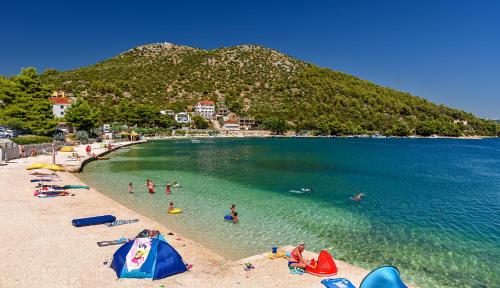 a group of people in the water at a beach at Villas Lucy - 1 Lemon -outdoor pool , 2 Cherry-indoor pool and 3 Plum-outdoor pool in Marina