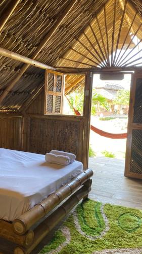 a bedroom with a bed in a hut at Guajira Beach in Ríohacha