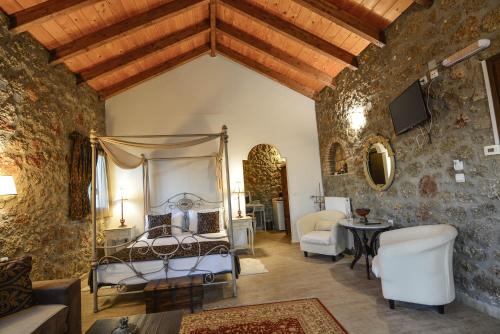 a bedroom with a bed in a room with stone walls at Trikalon Muses Art Suites in Synikia Mesi Trikalon