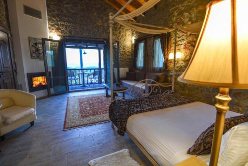 a bedroom with a bed with a lamp and a living room at Trikalon Muses Art Suites in Synikia Mesi Trikalon