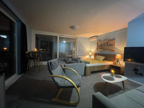 a living room with a bed and a couch at Amazing Penthouse old town in Sarajevo