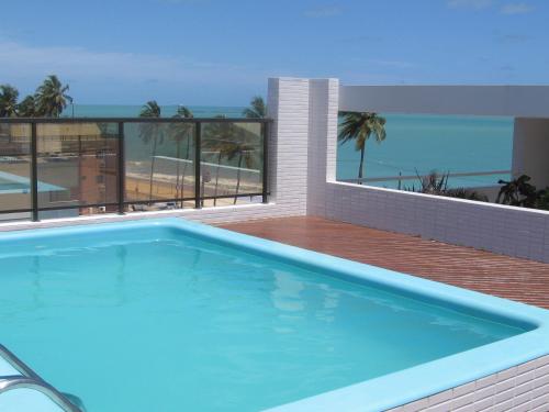 a swimming pool on a balcony with a view of the beach at Mardisa Flat Frente Mar in João Pessoa