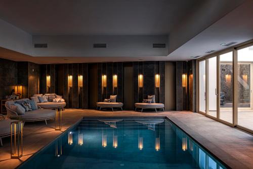 a swimming pool in a hotel room with furniture at Dionis Boutique Hotel & Spa in Jávea