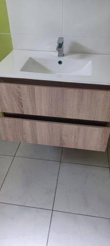 a bathroom sink with a white counter top at Nature & Zénitude - Morne-à-l'Eau 