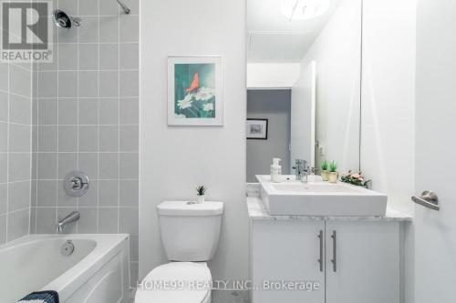 a bathroom with a toilet and a sink and a tub at Gorgeous Condo in Downtown Near CN Tower in Toronto