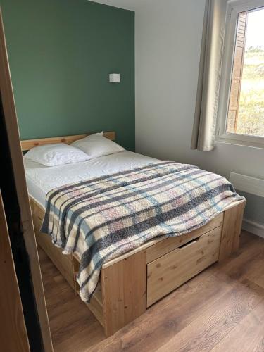 a bedroom with a bed with a blanket on it at Les 100 Ciels Font-Romeu in Font Romeu Odeillo Via