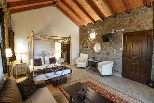 a bedroom with a bed and a living room at Trikalon Muses Art Suites in Synikia Mesi Trikalon