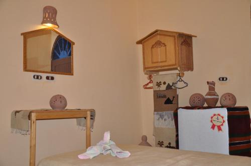 a room with boxes and a table and a clock at Oasis Panorama Hotel in Bawiti