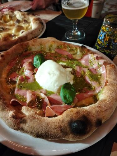 two pizzas sitting on a plate on a table at Appartamento Porto Marina S G 2 in Licata