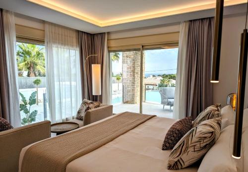 a hotel room with a large bed and a balcony at Dionis Boutique Hotel & Spa in Jávea