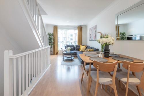 a living room with a table and a couch at 2 Bed town house with Garden in Hackney, London in London