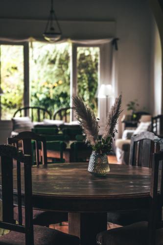 a dining room table with a plant on top of it at HOSTAL CRUZ CHICA in La Cumbre
