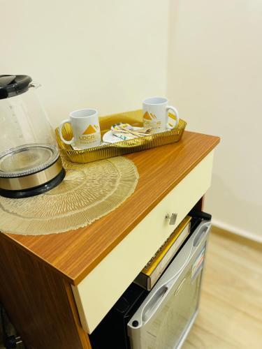 a counter with two cups and a tray on it at Locanda pyramids view in Cairo