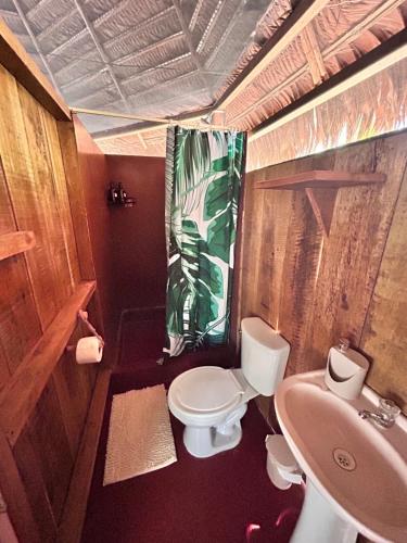 a small bathroom with a toilet and a sink at Eywa Lodge Amazonas - All inclusive in Yucuruche