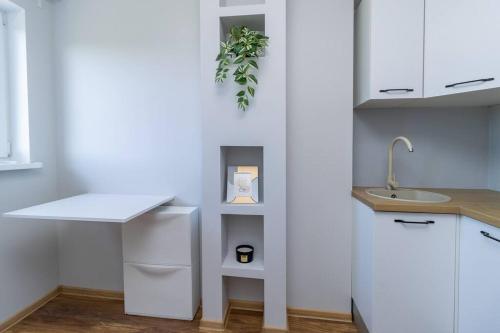 a kitchen with white cabinets and a sink and a counter at Studio flat in Tallinn