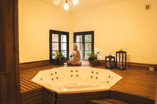 a large bath tub with a statue in a room at HOSTAL CRUZ CHICA in La Cumbre