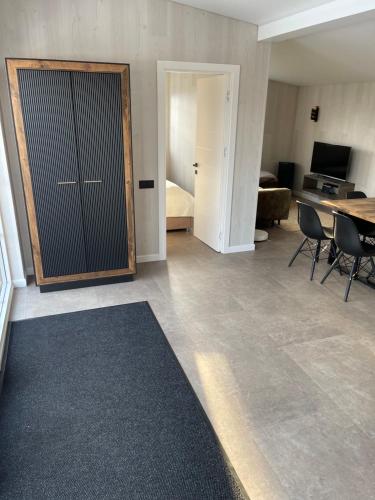 a room with a sliding door with a table and chairs at Holiday house near the city in Būdviečiai