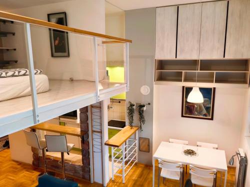 a small apartment with a bunk bed and a table and chairs at Apartman Stepa K3 in Belgrade