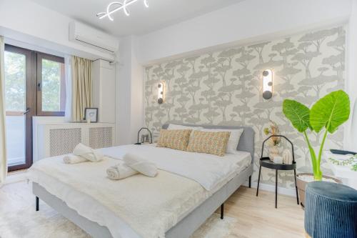 a bedroom with a large bed with two pillows at Hi-lux Ultracentral - 4BR Superior - Amazing View in Bucharest