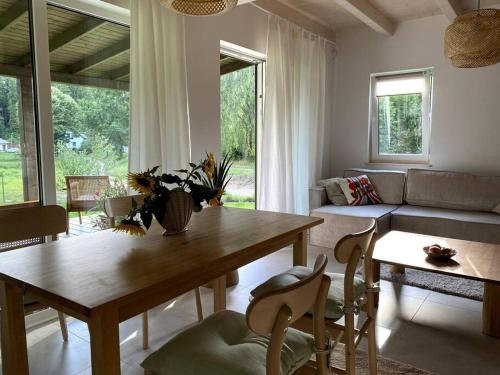 a living room with a table and a couch at Stodoła Drwęck in Drwęck