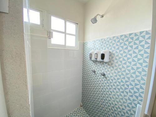 a bathroom with a shower with a window and a glass door at Ubicación top: Depto. a 3 min de la playa in Veracruz