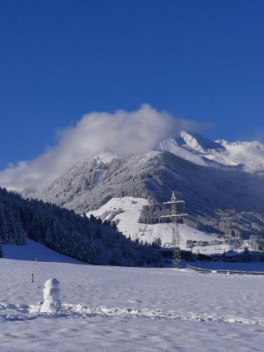 a snow covered mountain with a ski lift in the background at Die Wiesen Apartments in Innsbruck