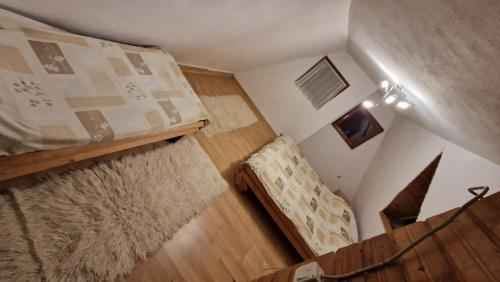 a small room with a bunk bed and a staircase at VilaBellavistasmjestaj in Vlasic